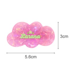 A pink iridescent hair clip shaped like a cloud with a logo, measuring 5.6cm by 3cm.