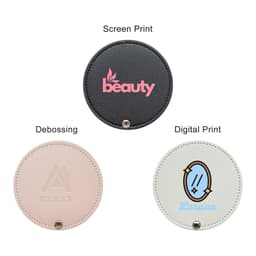 A round makeup mirror featuring three design options: black, pink, and cream with various prints and a logo.