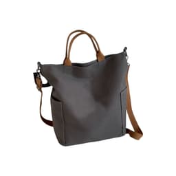 A grey vintage style canvas bag with brown straps and two side pockets, featuring a small logo.