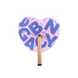 A heart-shaped wooden paper fan features a pink design with bold blue letters and a wooden handle.