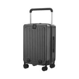 A grey hardside suitcase with a retractable handle and four wheels, featuring vertical grooves and a brand logo.
