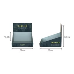 A corrugated cardboard counter display in dark grey and green, featuring an angled design for product placement.