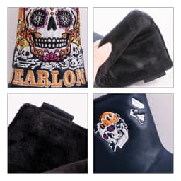 A decorative black putter cover featuring colourful skull designs and a soft interior lining, with branding present.