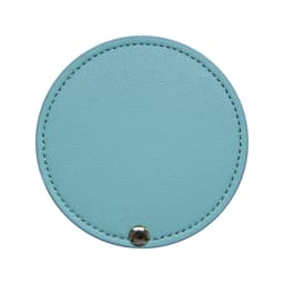 A round makeup mirror in a light blue colour with a stitched edge and a small metallic button.