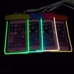Four waterproof phone bags in vibrant colours, featuring fluorescent outlines and interlocking closures, each holding a phone.