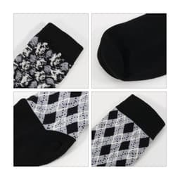 Four pairs of socks featuring different patterns, including a black and white design and an argyle pattern, with black sections.