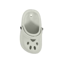 A grey paw-shaped clog shoe fridge magnet with ventilation holes and a black button detail.