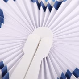 A peach-shaped plastic fan with a white handle and a blue and white pleated design.