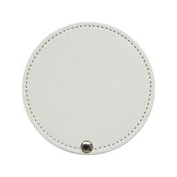 A round white makeup mirror with a textured surface and a small silver button detail. It has a subtle stitching around the edge.