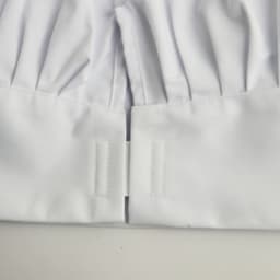White adult chef hat with pleated design and fastening at the base, featuring a smooth fabric texture.