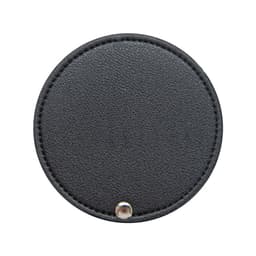 A round black makeup mirror with a stitched edge and a metal snap closure. It features a logo on the surface.
