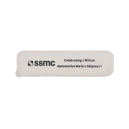 A rectangular, light grey eco-friendly token with a logo and text celebrating automotive wafer shipments.