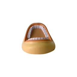 A mouth-shaped stress reliever in beige and white, featuring detailed teeth and an open design. Includes branding.