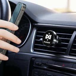 A black rotatable clip-on car phone holder is attached to an air vent, with a hand holding a smartphone nearby.