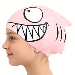 A pink silicone swim cap with a fish design, featuring a large smiling face and fins, shown on a child's head.
