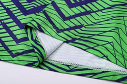 A vibrant green and navy patterned unisex long sleeve shirt featuring a V-neck design and soft fabric.