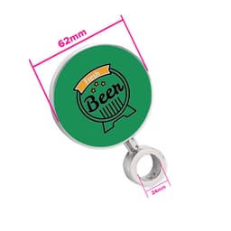 A circular green beer tap badge with a silver attachment, featuring a decorative design. Measures 62mm in diameter.