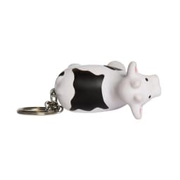 A keyring featuring a white and black cow stress reliever with a metal keychain attachment.