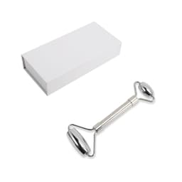 A stainless steel facial roller with a sleek design, accompanied by a plain white box for packaging.