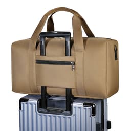A durable duffle bag in a tan colour, featuring a zipper pocket, resting on top of a silver suitcase.