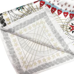 A silk satin scarf featuring a vibrant design with red hearts and star patterns on a white background.