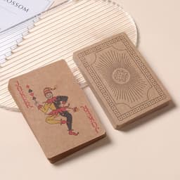 Kraft paper playing cards in brown, featuring a Joker design on one and a decorative back on the other.