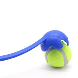 A blue ball thrower holds a green tennis ball, featuring a textured grip and curved handle for easy use.