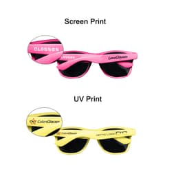 Coloured sunglasses in vibrant pink and yellow with dark lenses, featuring distinctive prints on each arm.