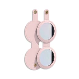 A round folding pocket mirror in a soft pink casing, featuring a logo on the front and two mirrored surfaces.