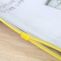 A transparent A4 file bag with a yellow zipper and fastener, featuring loose papers inside.