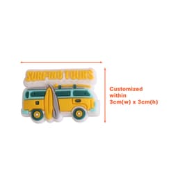 A yellow and green Clog Shoe Charm in the shape of a van with a surfboard and text above it.