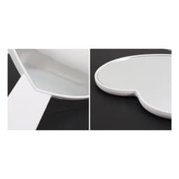 A heart-shaped handheld mirror with a white handle, featuring a smooth reflective surface.