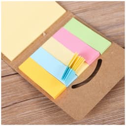 A mini sticky notes and flag set in various pastel colours, including yellow, pink, green, and blue, with a cardboard holder.