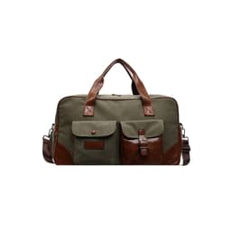 A vintage canvas duffle bag in green with brown leather accents and two front pockets. Features a logo.