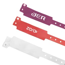 Three disposable PVC wristbands in purple, red, and white, featuring different logos and designs.