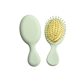 A mini paddle brush in pastel green, featuring a smooth oval design and rounded pins for gentle grooming.