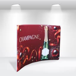 A tabletop tension fabric display featuring a champagne bottle on a red background with decorative ribbons and ornaments.