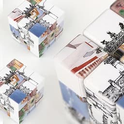 A set of colourful 3x3 puzzle cubes featuring various intricate designs and patterns, with a logo visible.