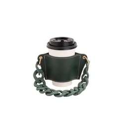 A drink bottle holder in green leather with a chunky acrylic strap, designed to hold a coffee cup.