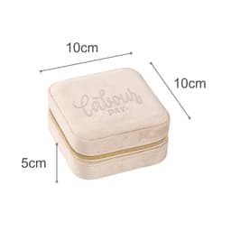 A velvet jewellery organiser in ivory, measuring 10cm x 10cm x 5cm, with a zip closure and a subtle logo.