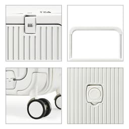 A white hardside suitcase with a locking mechanism, extendable handle, and wheels. Features a ribbed texture.