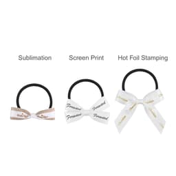 Three elastic hair bows in black, with white bows featuring various designs and printing styles.