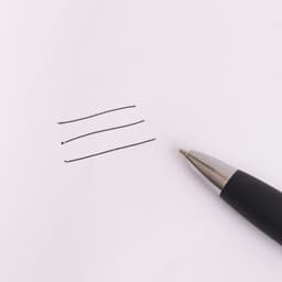 A black stylus pen rests beside three straight lines drawn on white paper. The pen has a sleek design and shiny tip.