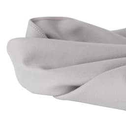 A quick-dry towel in a soft grey colour, featuring a smooth, folded edge, with a logo present.