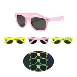 Glow in the dark sunglasses in pink and neon green, featuring different styles and a logo on some pairs.
