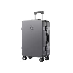 A grey ribbed ABS suitcase with a retractable handle and wheels, featuring a logo on the front.