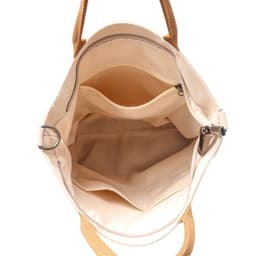 An interior view of a vintage style canvas bag in cream with tan handles and multiple compartments.
