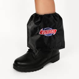 Waterproof black boot covers with an elastic top, fitting over a black boot, featuring a logo.