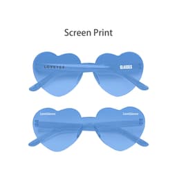 Heart-shaped sunglasses in a blue tint with a clear frame and branding on the arms.