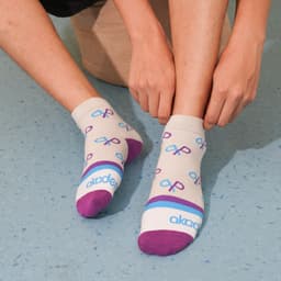 Ankle socks with a custom pattern featuring purple and blue designs on a light grey background, with towel-bottom construction.